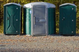 ada porta potty next to two normal units